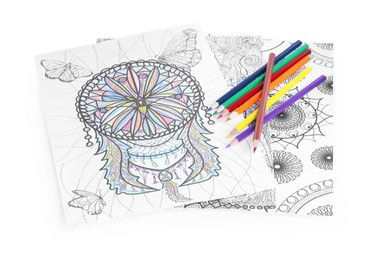 Photo of Antistress coloring pages and pencils on white background