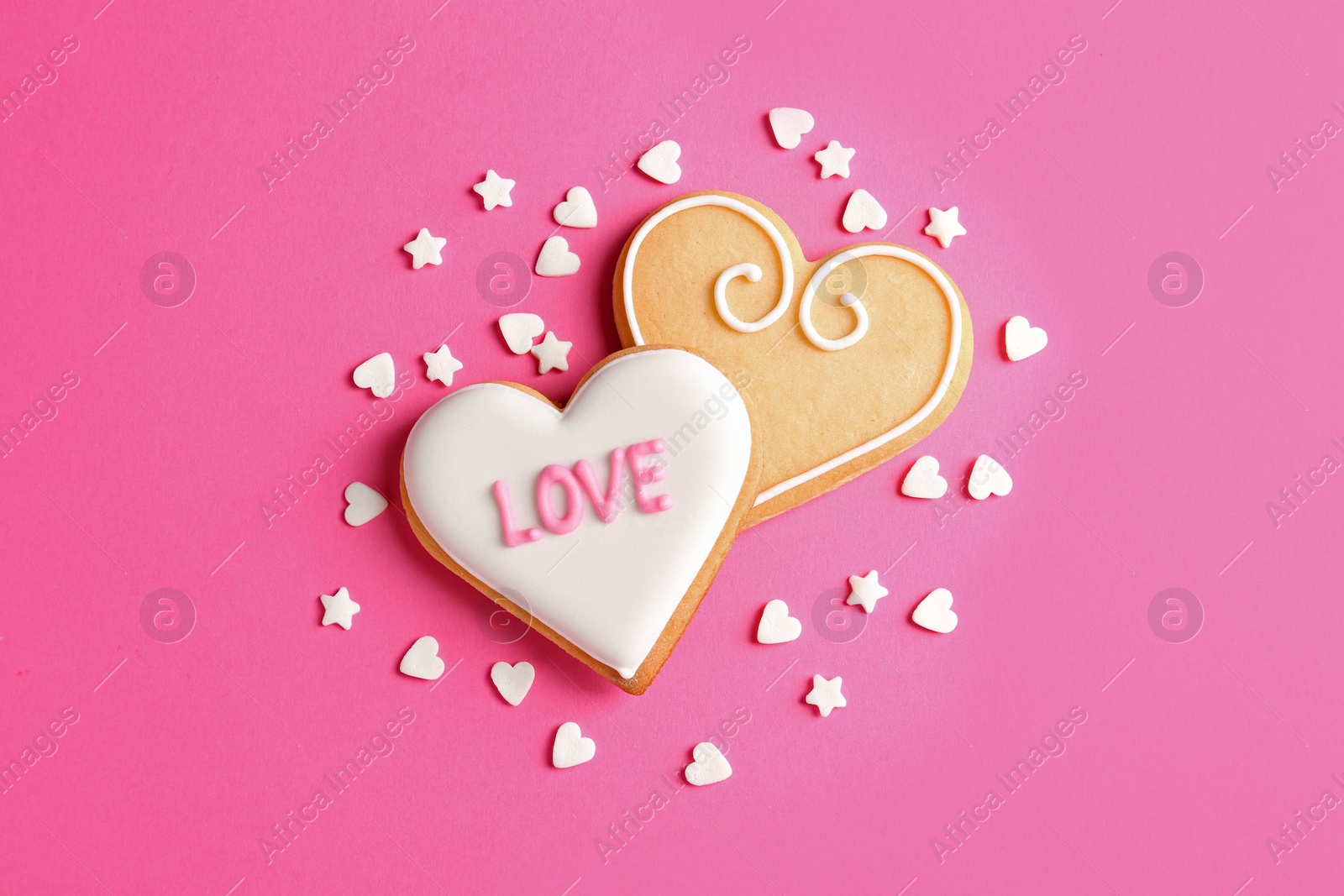 Photo of Composition with decorated heart shaped cookies on color background, top view. Valentine's day treat