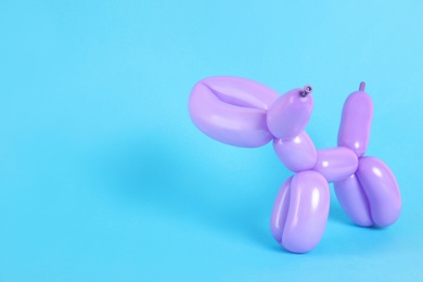 Photo of Animal figure made of modelling balloon on color background. Space for text