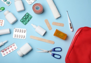 Flat lay composition with first aid kit on color background