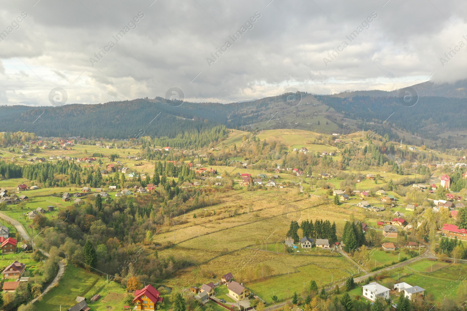 Photo of Aerial view of beautiful forest and mountain village on autumn day