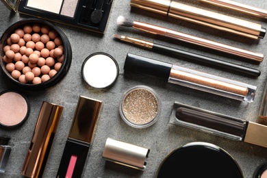 Photo of Set of luxury makeup products on grey background, flat lay