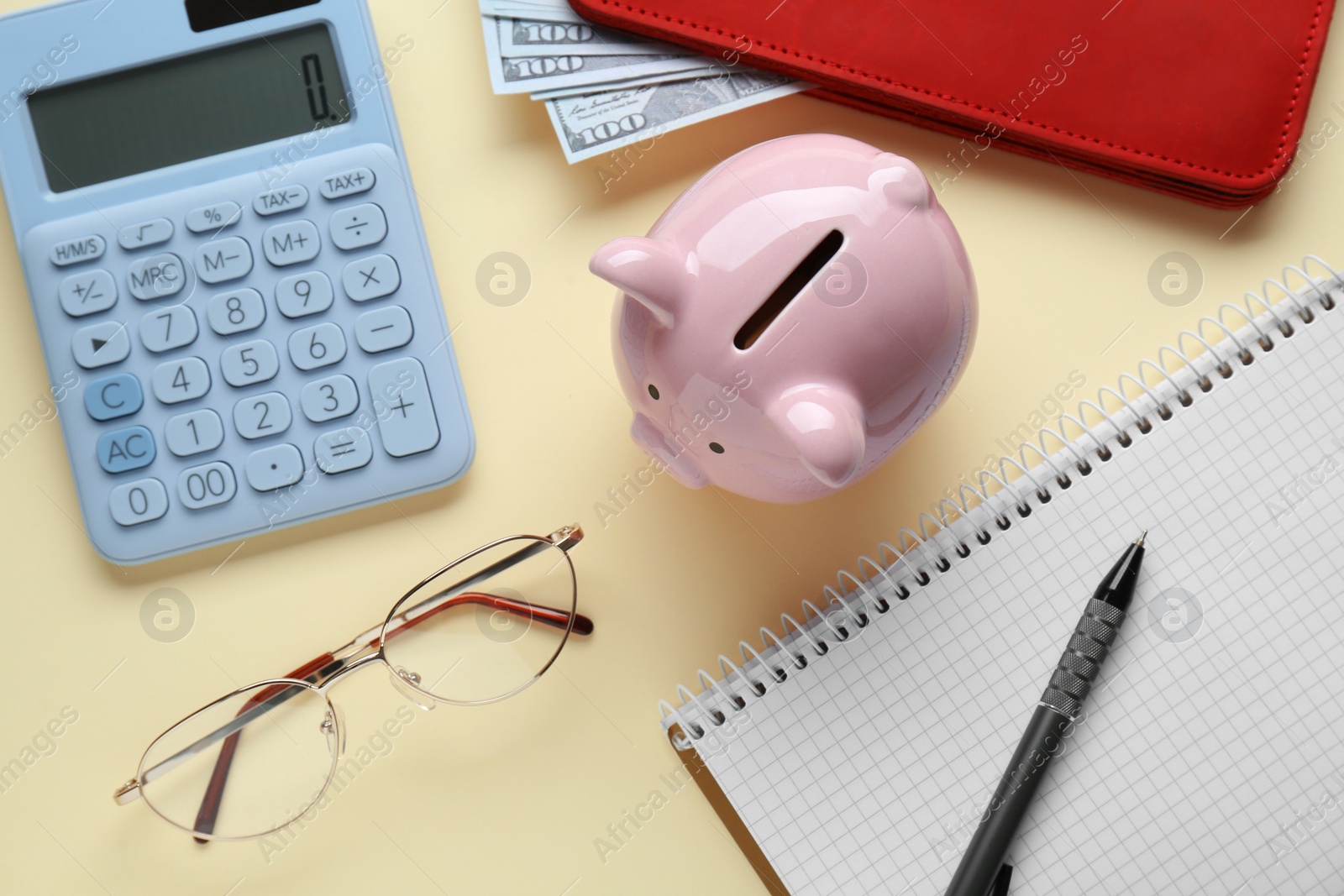 Photo of Flat lay composition with piggy bank, banknotes and glasses on beige background