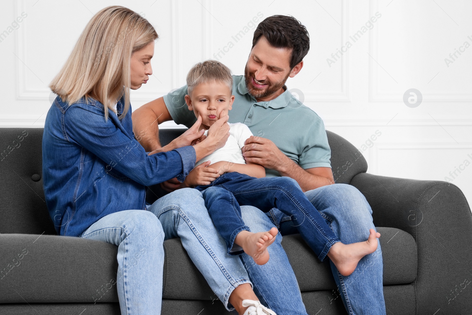 Photo of Happy family having fun together on sofa at home