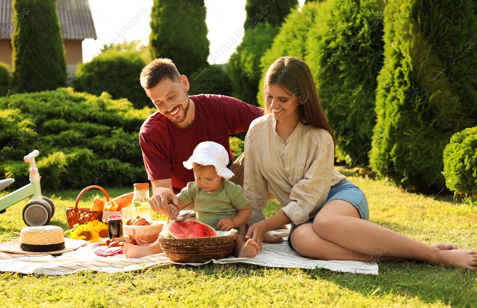 Photo of Happy family having picnic in garden on sunny day