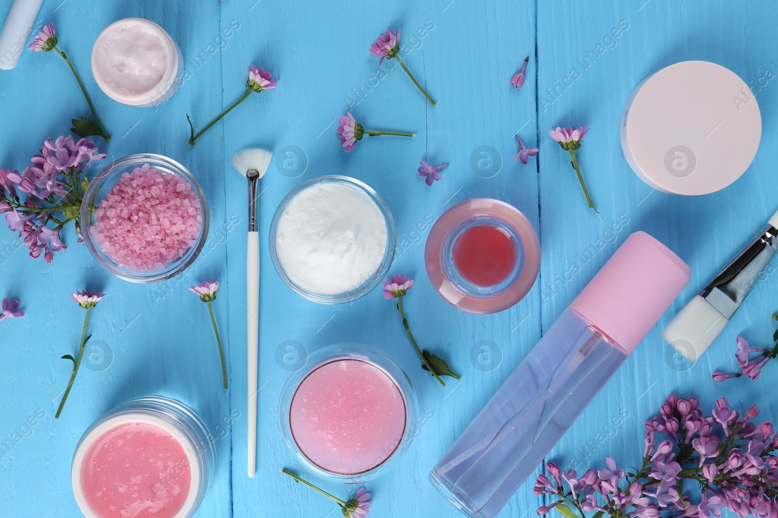 Photo of Flat lay composition with homemade cosmetic products and fresh ingredients on light blue wooden table