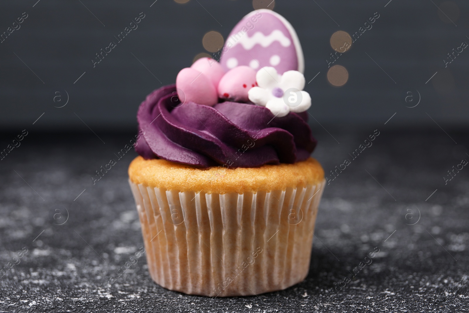 Photo of Tasty decorated Easter cupcake on grey table, closeup