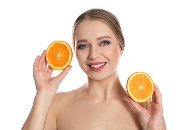 Photo of Young woman with cut orange on white background. Vitamin rich food