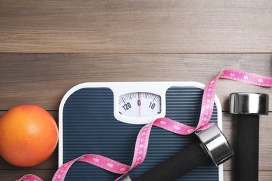 Photo of Flat lay composition with scales on wooden table, space for text