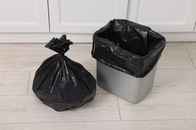 Photo of Plastic garbage bag and trash can indoors