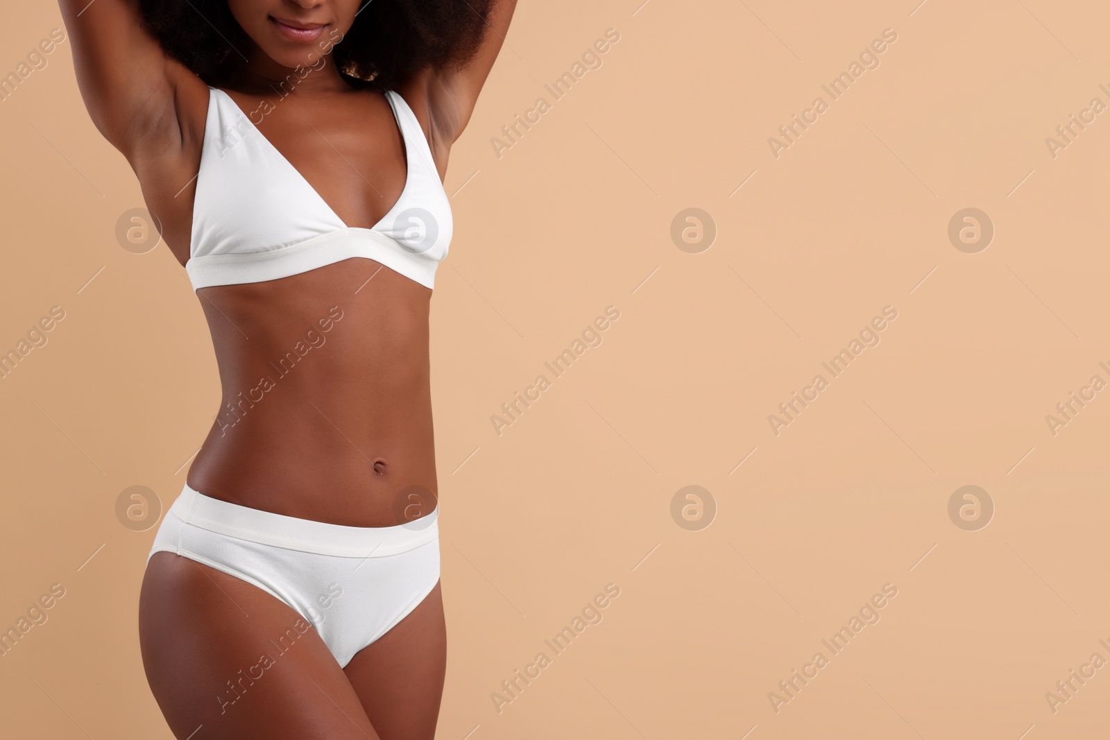 Photo of Woman in stylish bikini on beige background, closeup. Space for text