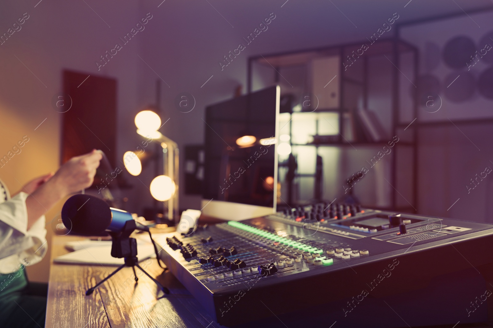 Photo of Woman working as radio host in modern studio, focus on professional mixing console. Space for text