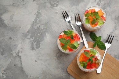 Delicious broken glass jelly dessert on white marble table, flat lay. Space for text