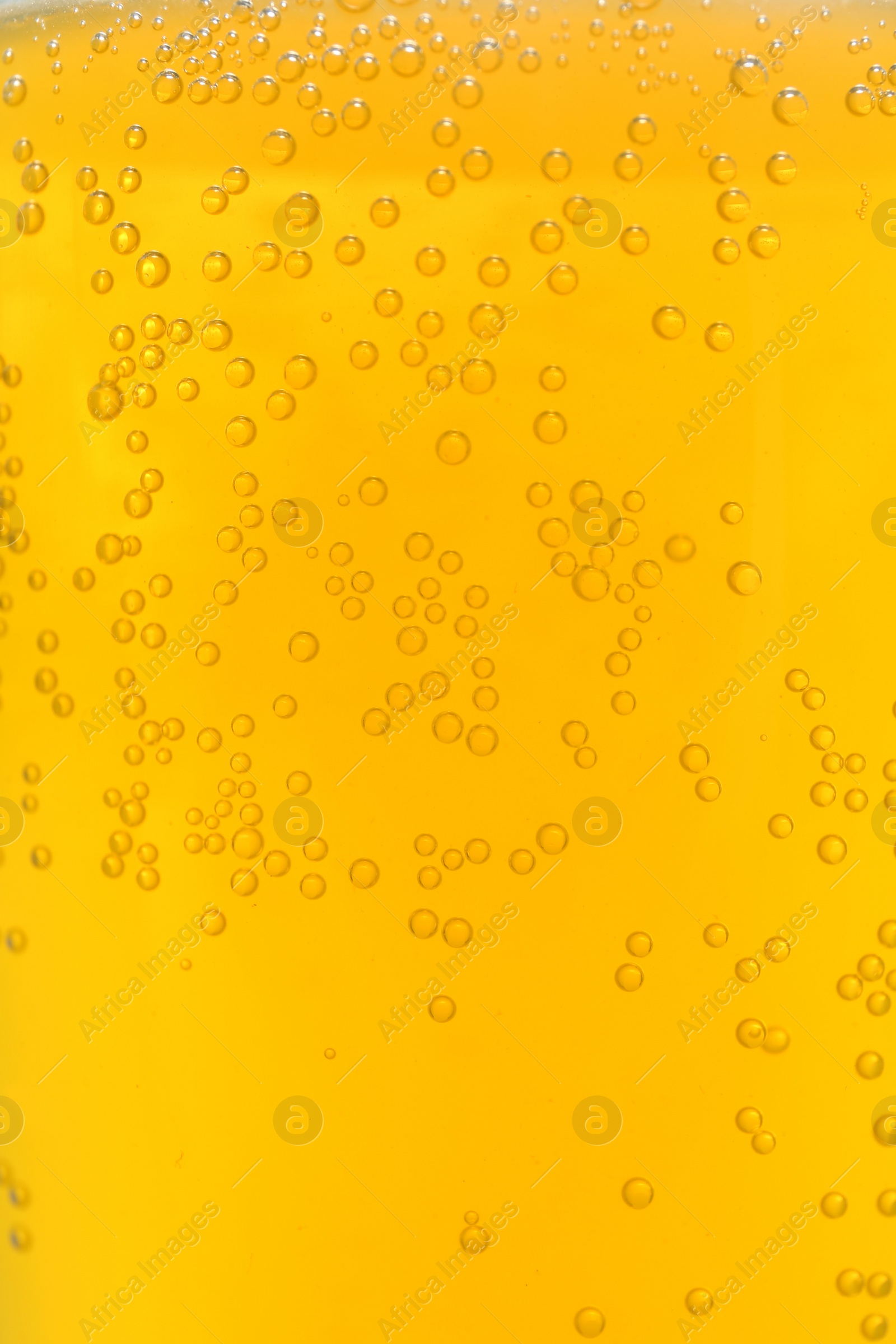 Photo of Orange drink with bubbles as background, closeup