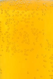 Photo of Orange drink with bubbles as background, closeup