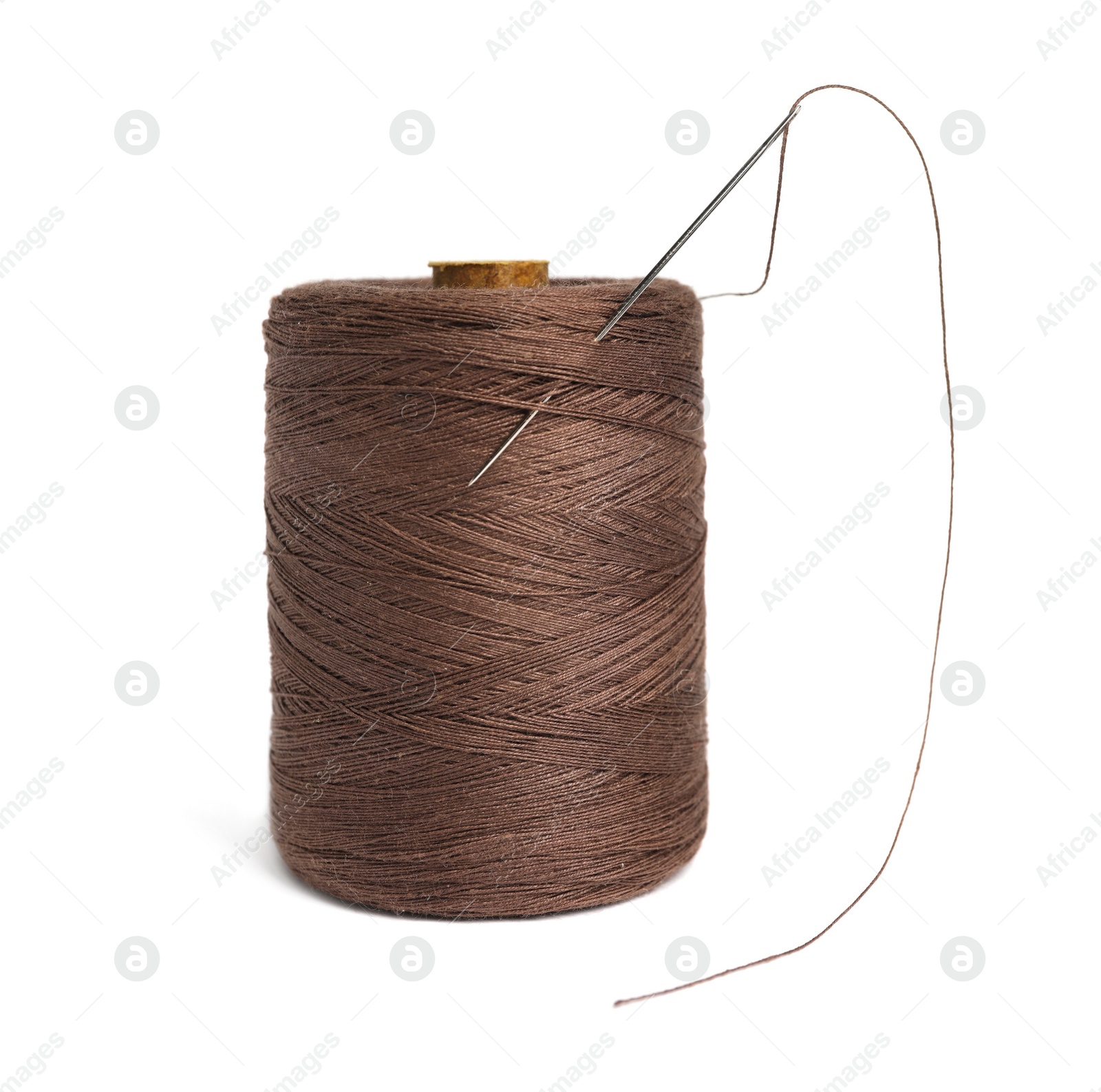 Photo of Brown sewing thread with needle on white background