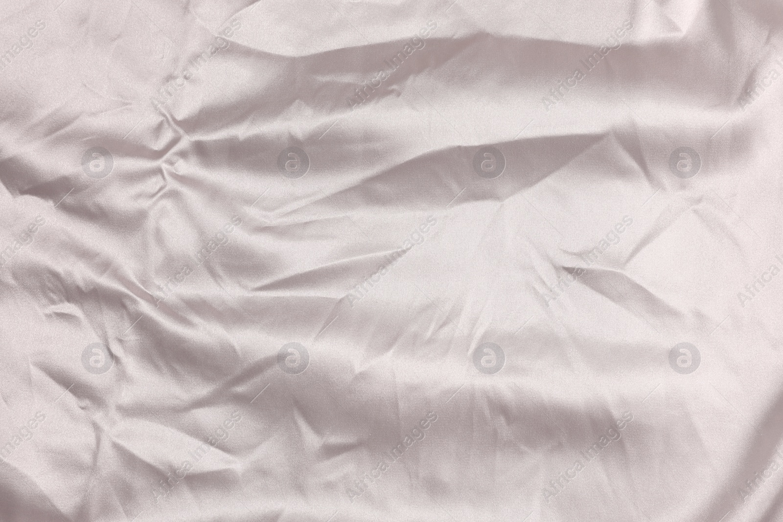 Photo of Crumpled light pink fabric as background, top view