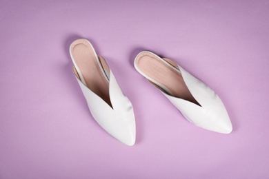 Photo of Pair of female shoes on color background, top view