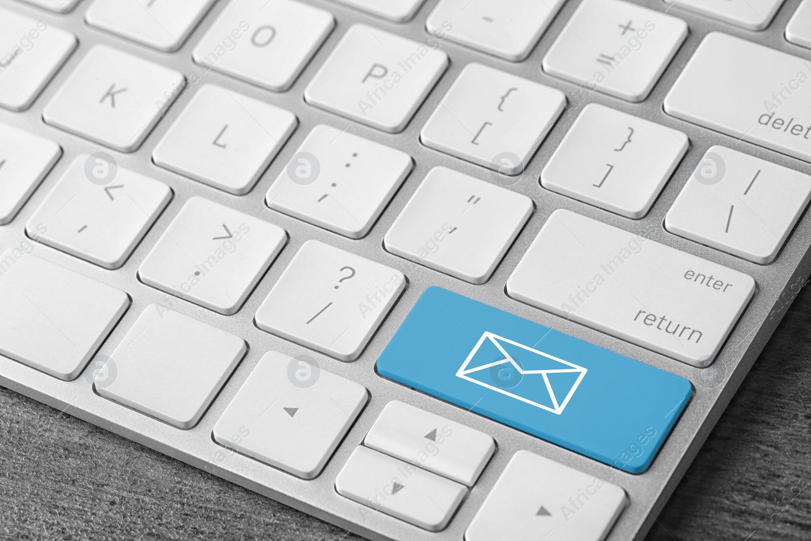 Image of Modern computer keyboard with envelope sign on button, closeup view. Sending email letters