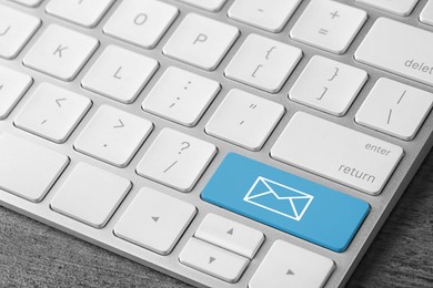 Modern computer keyboard with envelope sign on button, closeup view. Sending email letters