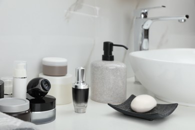 Photo of Camera hidden among different toiletries on table in bathroom
