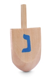 Photo of Wooden Hanukkah traditional dreidel with letter Nun isolated on white