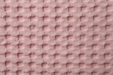 Photo of Texture of pink knitted fabric as background, top view