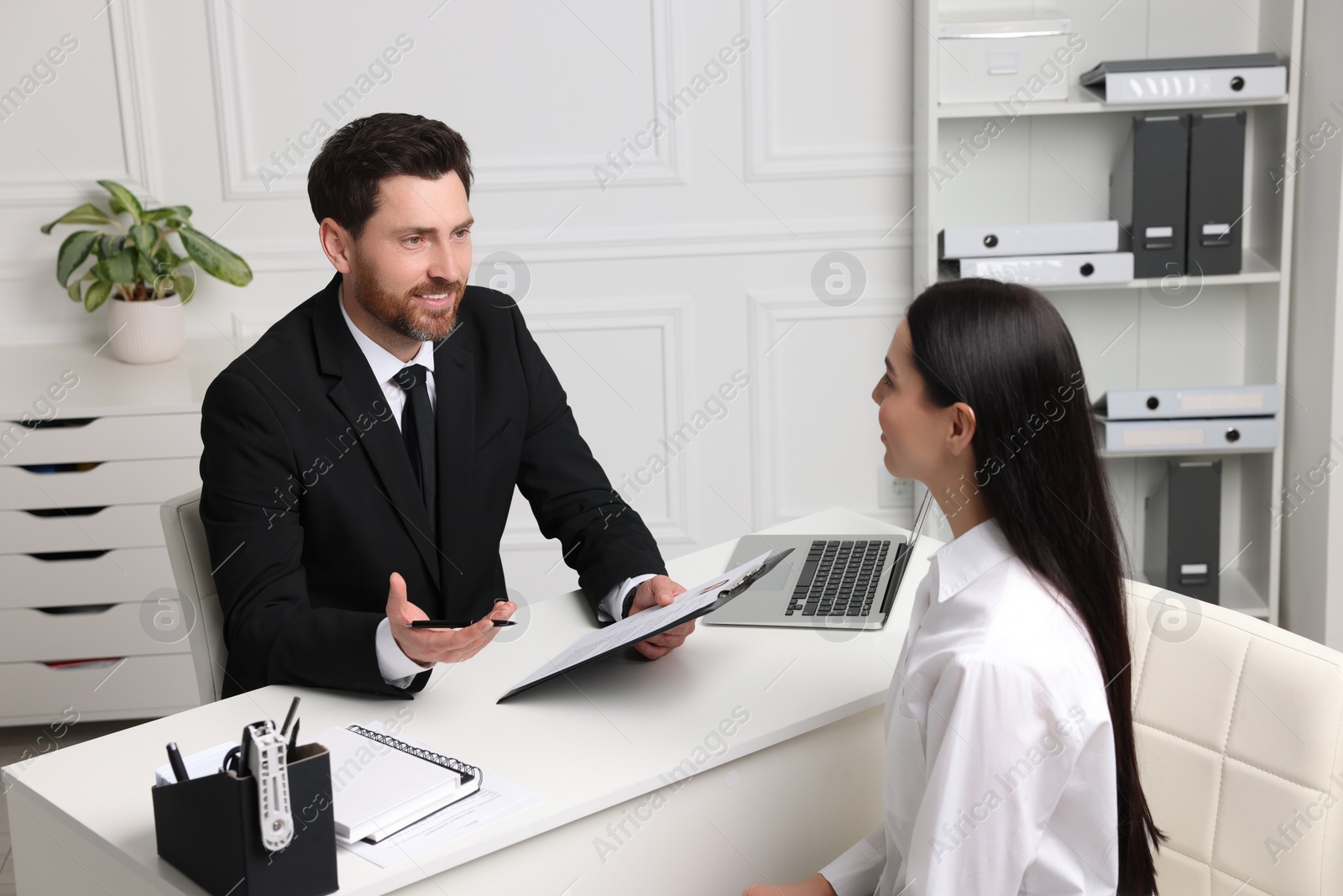 Photo of Human resources manager conducting job interview with applicant in office