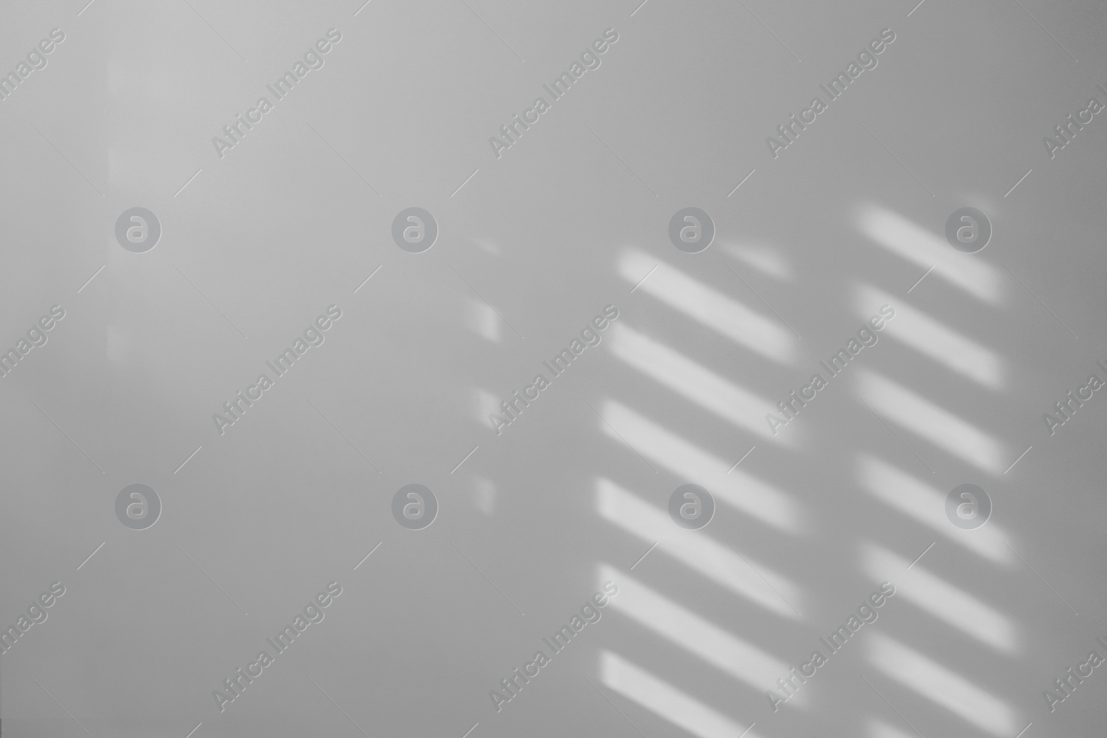 Image of Light and shadows falling on white wall