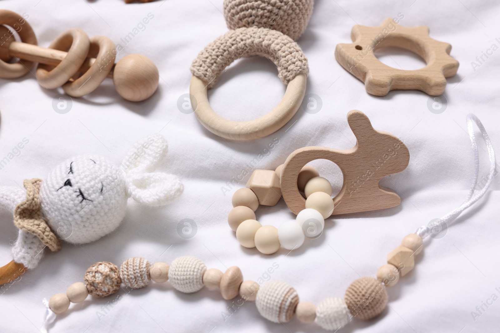 Photo of Many different baby accessories on white fabric