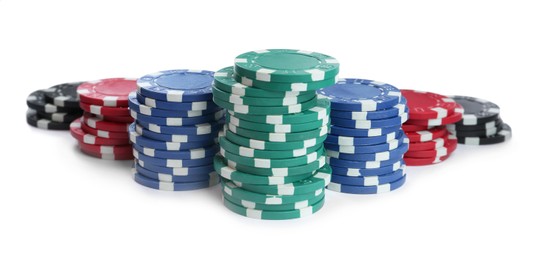 Photo of Plastic casino chips stacked on white background. Poker game