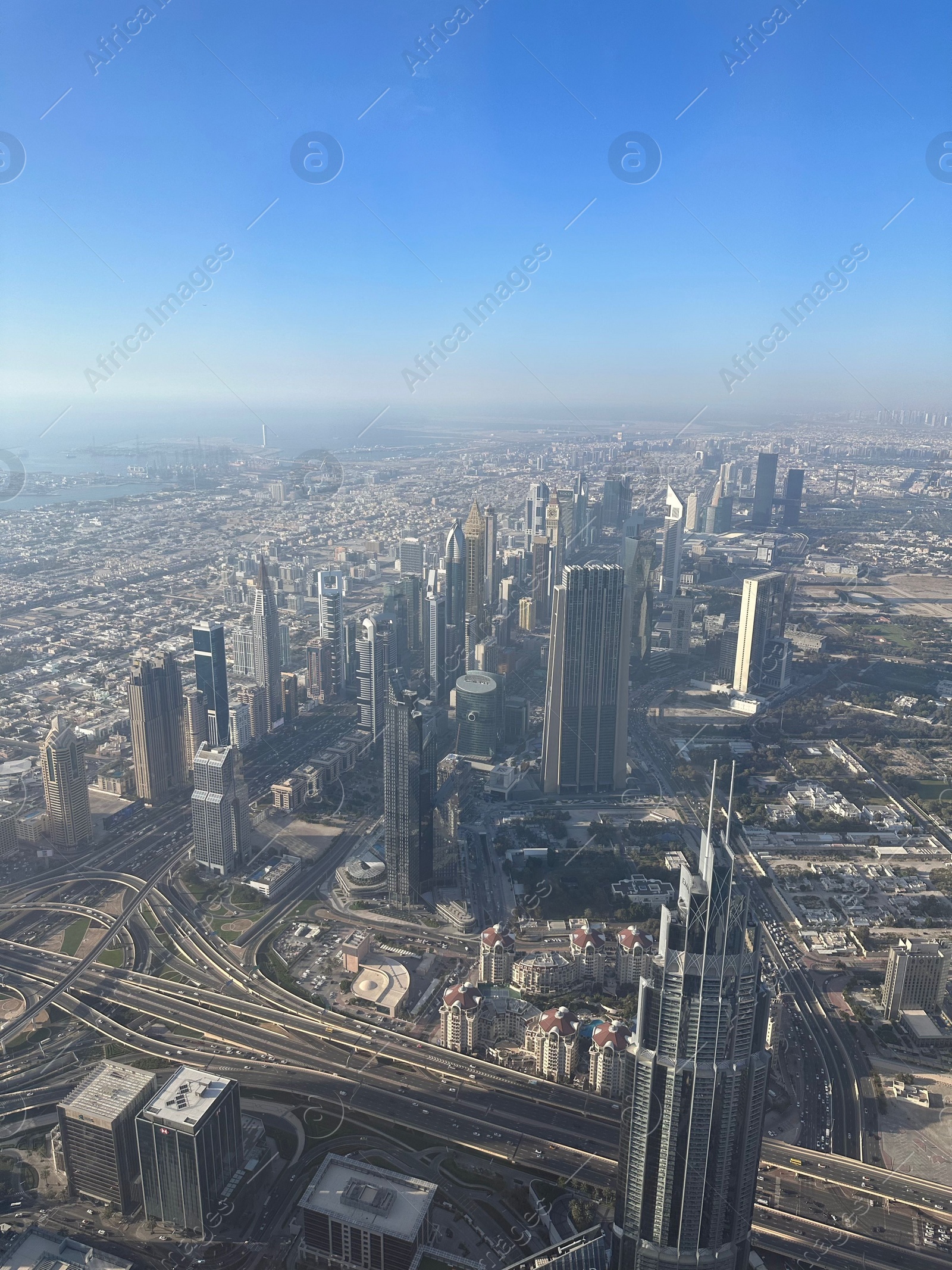 Photo of Dubai, United Arab Emirates - May 2, 2023: Picturesque view of city with skyscrapers from Burj Khalifa