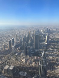 Dubai, United Arab Emirates - May 2, 2023: Picturesque view of city with skyscrapers from Burj Khalifa