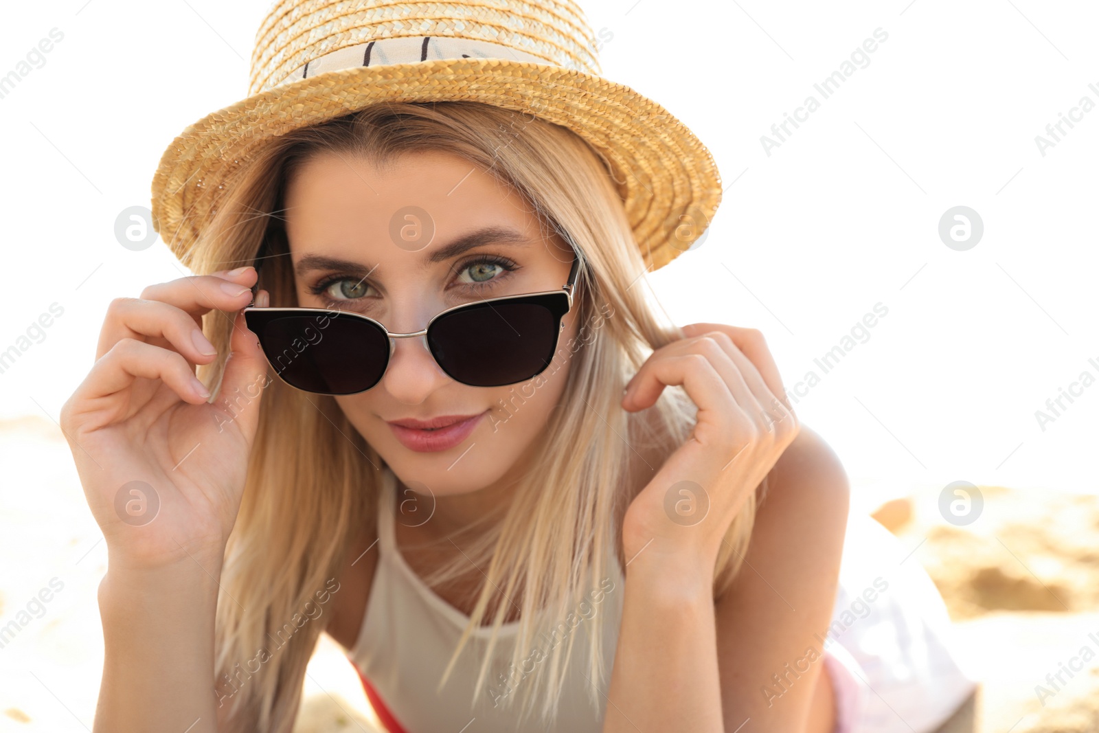 Photo of Beautiful woman wearing sunglasses outdoors on sunny day