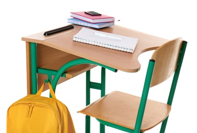 Wooden school desk with stationery and backpack on white background