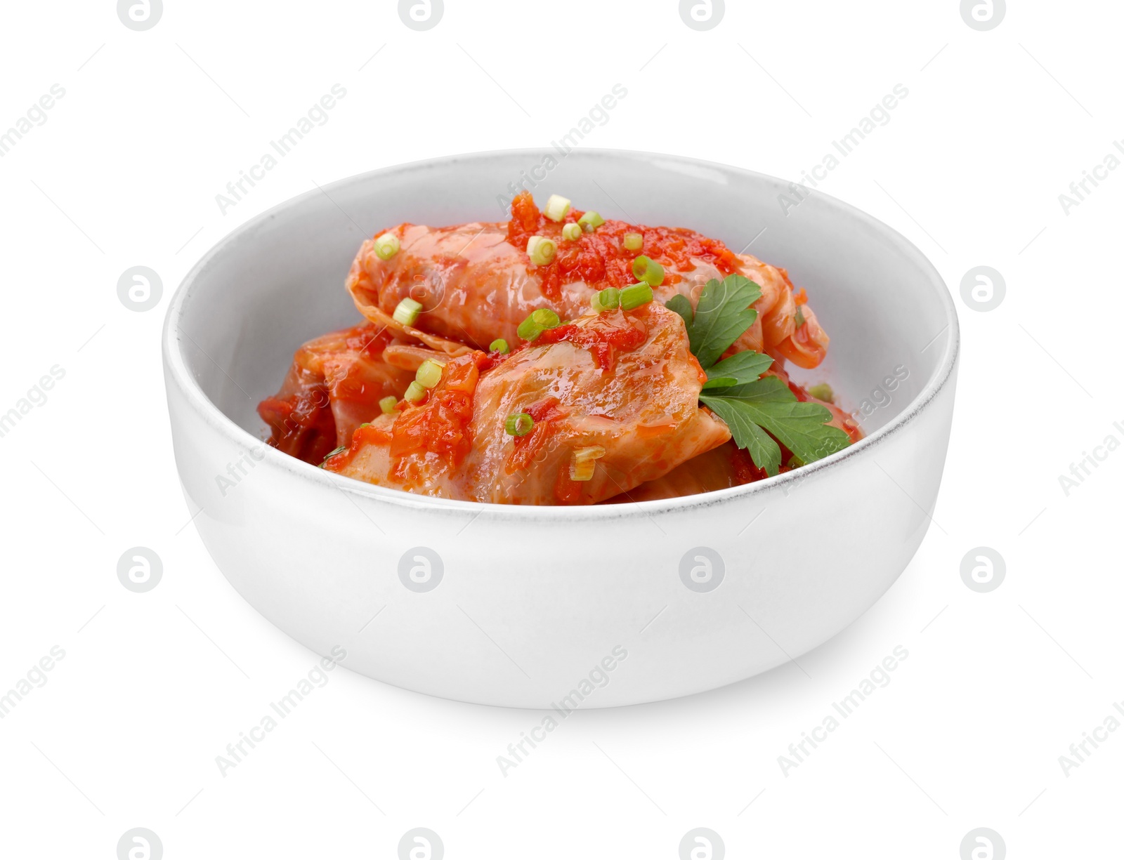 Photo of Bowl of delicious stuffed cabbage rolls cooked with homemade tomato sauce isolated on white