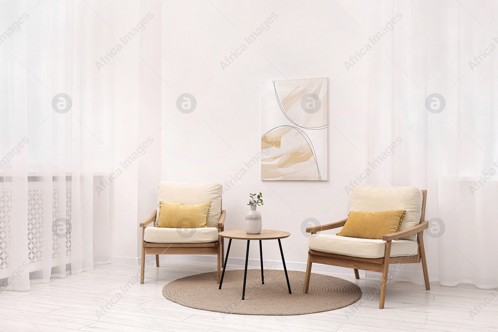 Photo of Stylish armchairs and wooden table in living room. Interior design