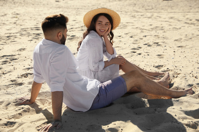 Photo of Happy young couple on sandy beach. Honeymoon trip