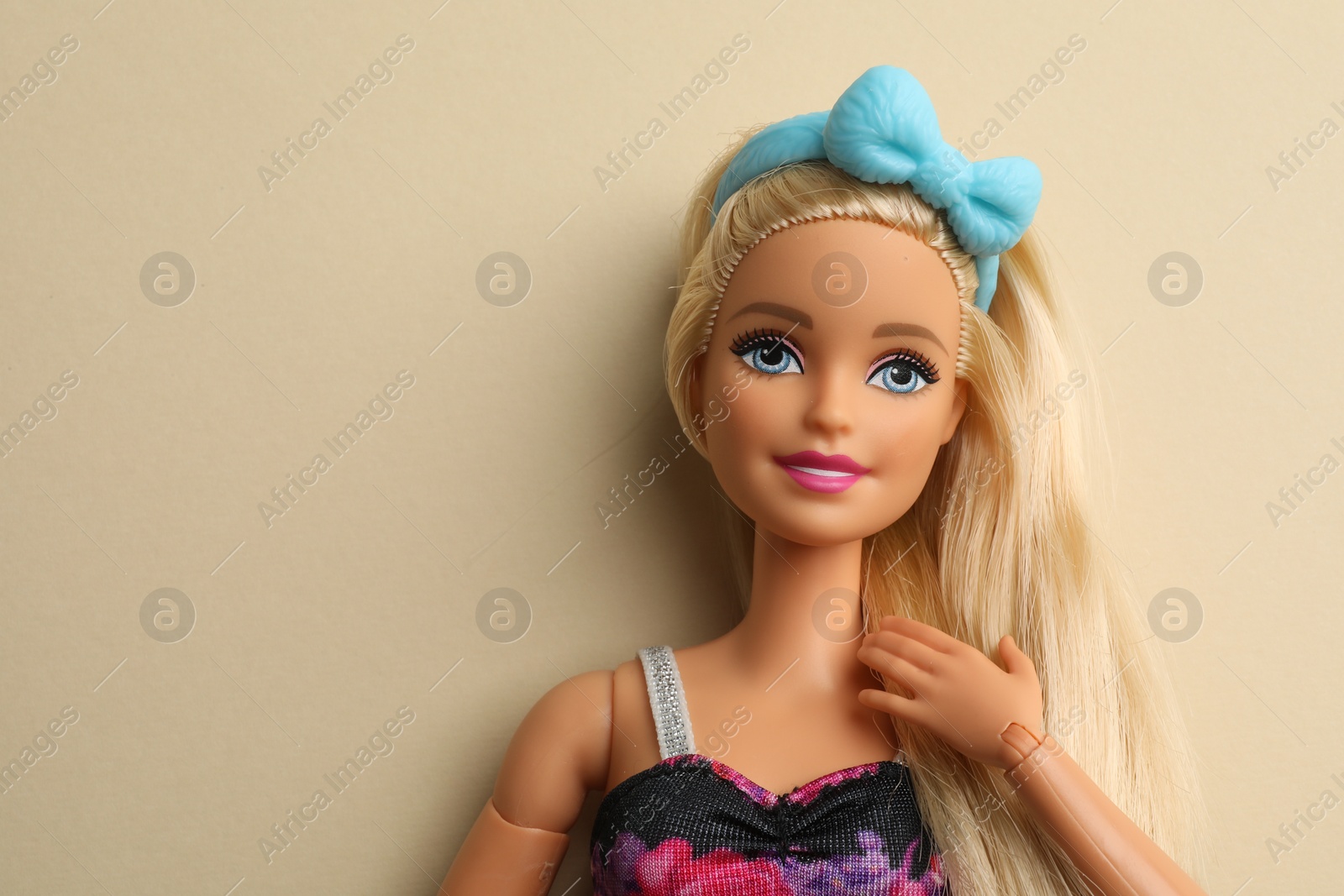 Photo of Mykolaiv, Ukraine - September 4, 2023: Beautiful Barbie doll on beige background, space for text