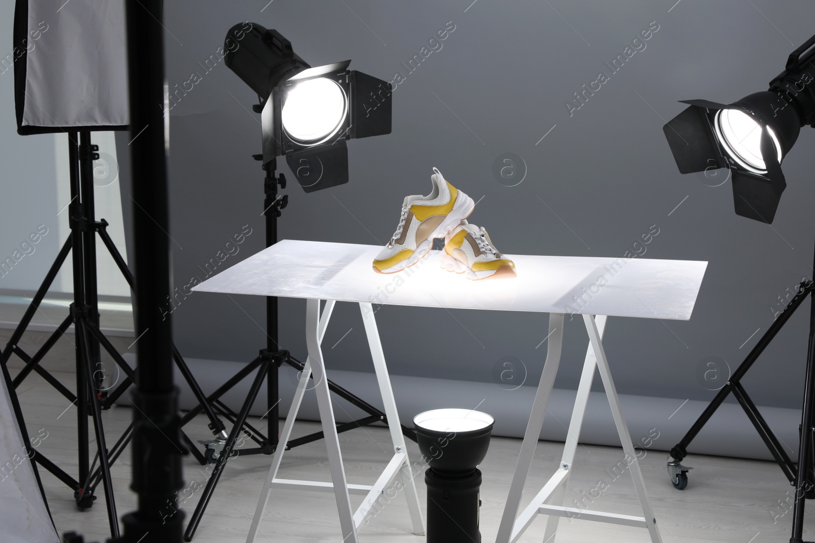 Photo of Professional photography equipment prepared for shooting stylish shoes in studio