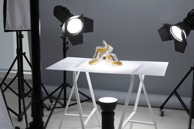 Photo of Professional photography equipment prepared for shooting stylish shoes in studio