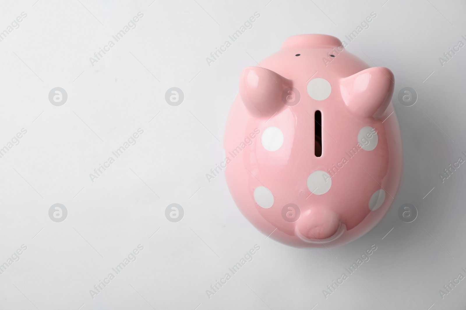 Photo of Pink piggy bank on white background, top view
