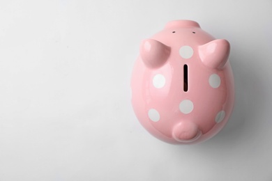 Photo of Pink piggy bank on white background, top view