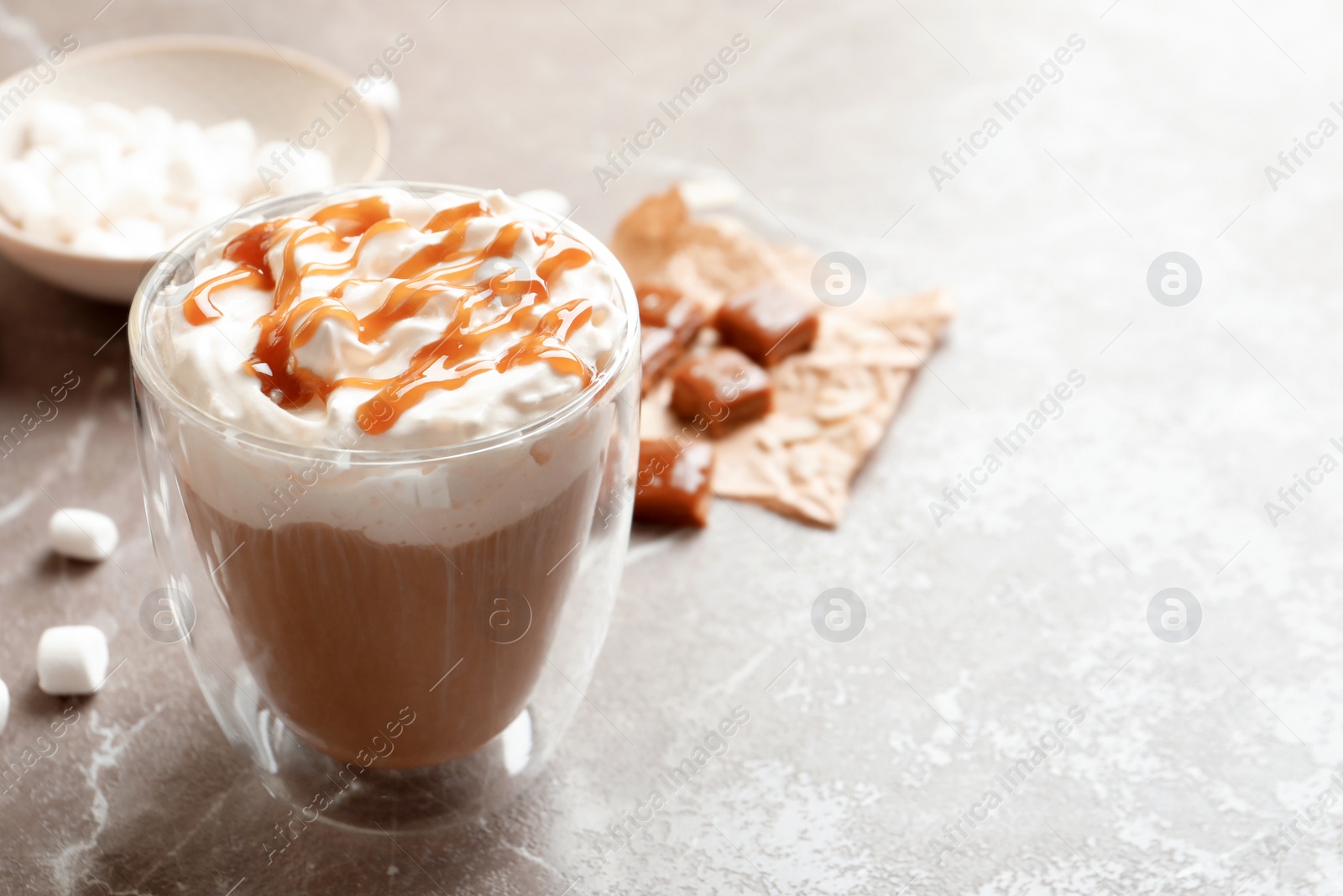 Photo of Cup of coffee with caramel topping on grey background