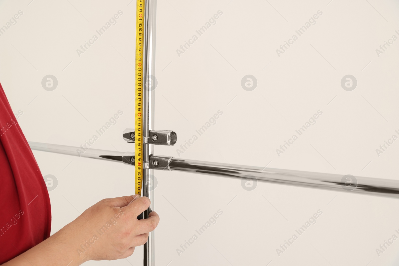 Photo of Worker measuring metal pipes for installation, closeup