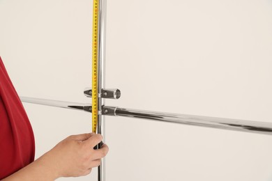 Photo of Worker measuring metal pipes for installation, closeup