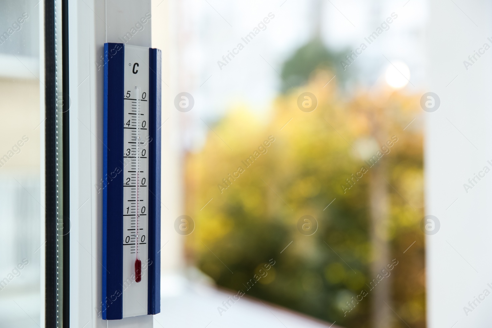 Photo of Weather thermometer on window frame indoors. Space for text