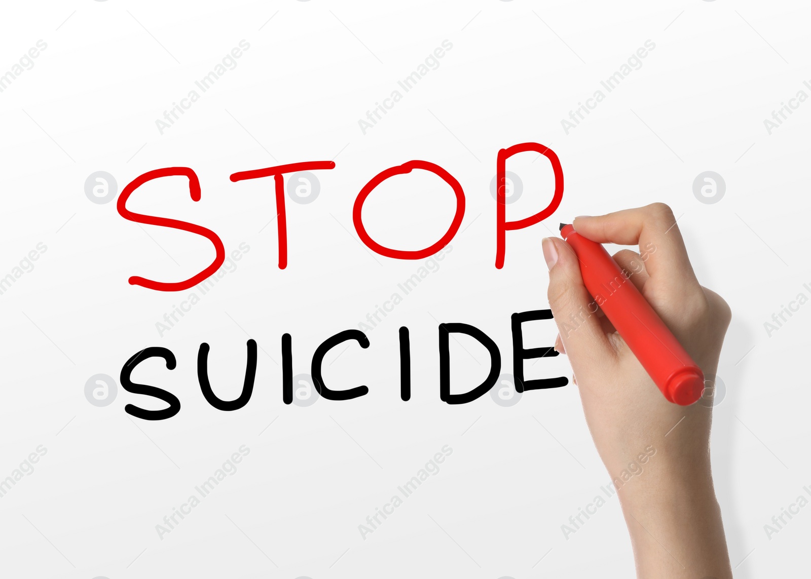 Image of Woman writing phrase Stop Suicide on whiteboard, closeup