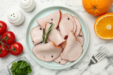 Photo of Delicious cut ham with rosemary and peppercorns served on white marble table, flat lay
