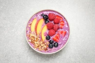 Photo of Healthy breakfast with delicious acai smoothie in bowl on light grey table, top view